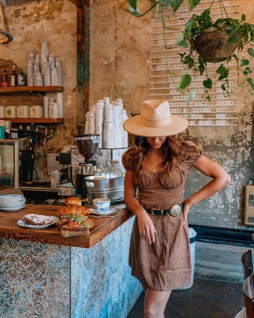 Illustrative café scene with a cappuccino and golden croissant in warm morning light